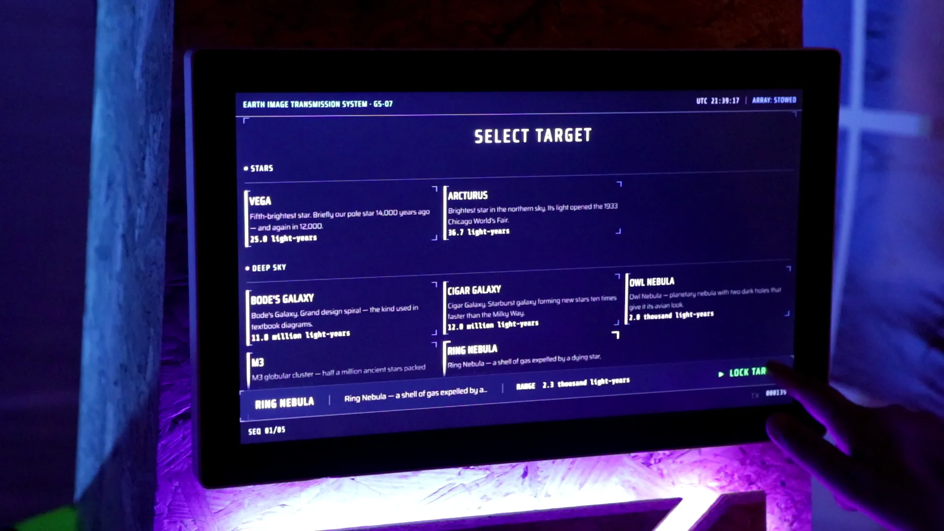 The booth screen showing the target picker, listing reachable celestial targets over an animated orbital plot.